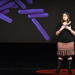 It is the image of Lara Durgavich who is a TED speaker and giving speech on Evoulution of Humans