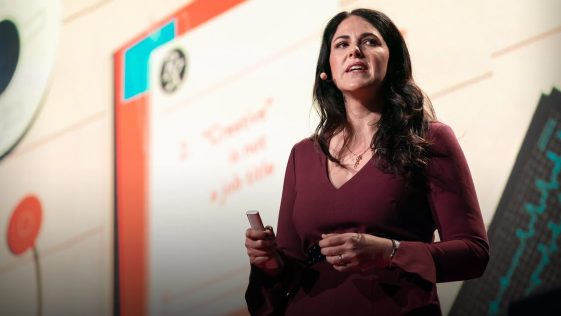 Picture of Lauren Braitman giving speech. Click on the picture to watch TED talk on mental helath Benefits for Heath care workers by Lauren Braitman